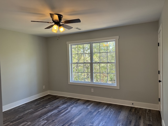 spare room with dark wood-type flooring and ceiling fan