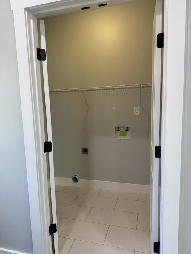 clothes washing area featuring hookup for a washing machine, electric dryer hookup, and light tile patterned floors