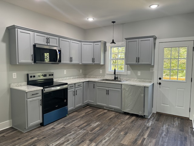 kitchen featuring appliances with stainless steel finishes, sink, plenty of natural light, and dark hardwood / wood-style flooring