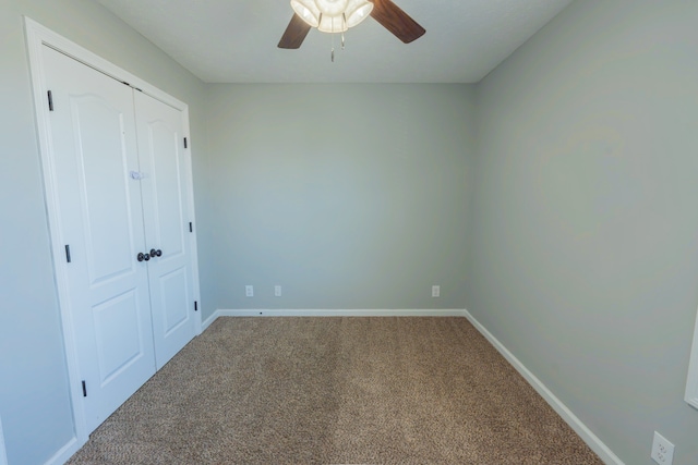 unfurnished bedroom with carpet floors, a closet, and ceiling fan