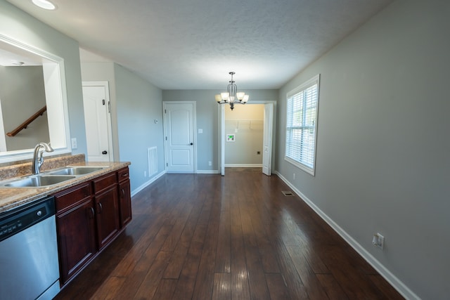 kitchen with dark hardwood / wood-style floors, sink, pendant lighting, an inviting chandelier, and stainless steel dishwasher