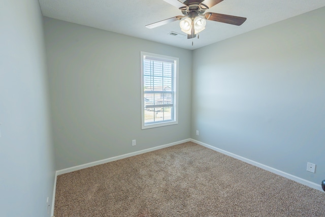 spare room with carpet and ceiling fan