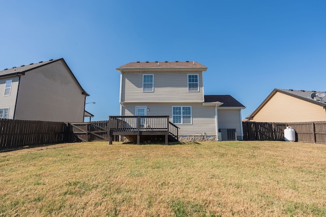 rear view of property with central AC, a yard, and a wooden deck