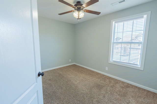 empty room with ceiling fan and carpet floors