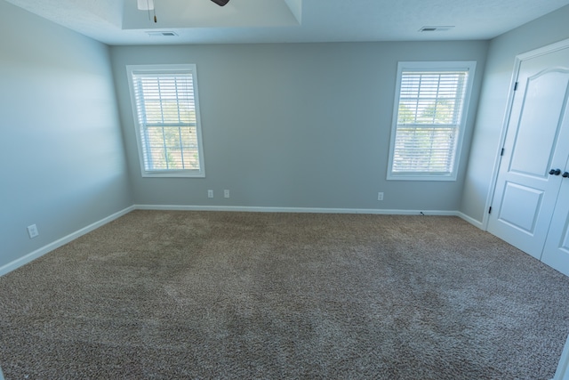 unfurnished room with carpet and ceiling fan