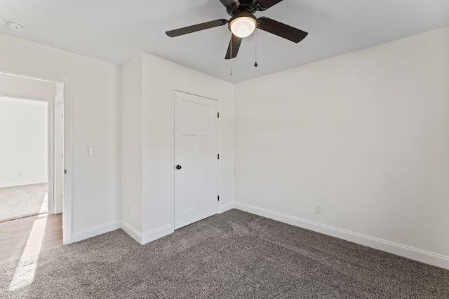 unfurnished bedroom with a closet, carpet, and ceiling fan