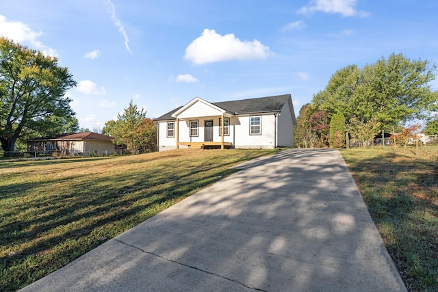 view of front facade with a front yard and covered porch