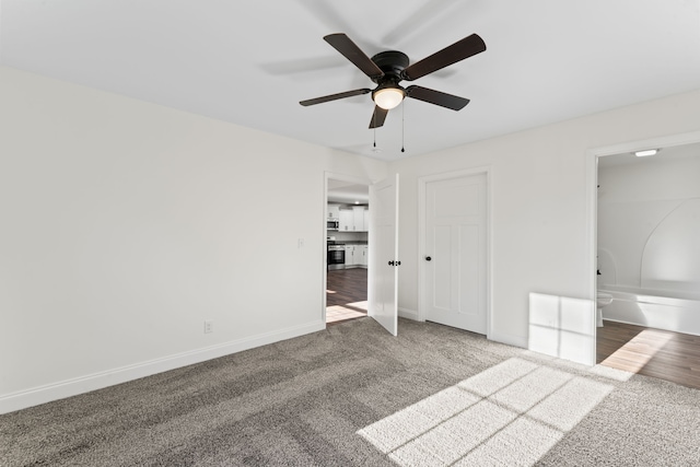 unfurnished bedroom with carpet, ceiling fan, and ensuite bath