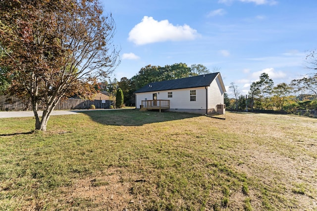 view of yard featuring a wooden deck and central AC unit