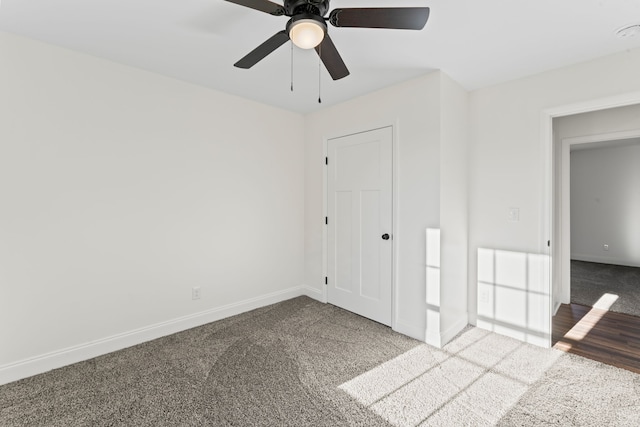 carpeted spare room featuring ceiling fan