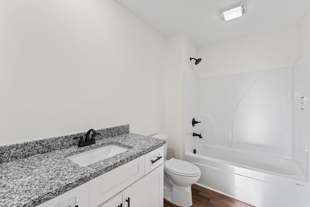 full bathroom with vanity, hardwood / wood-style floors, toilet, and shower / bathtub combination