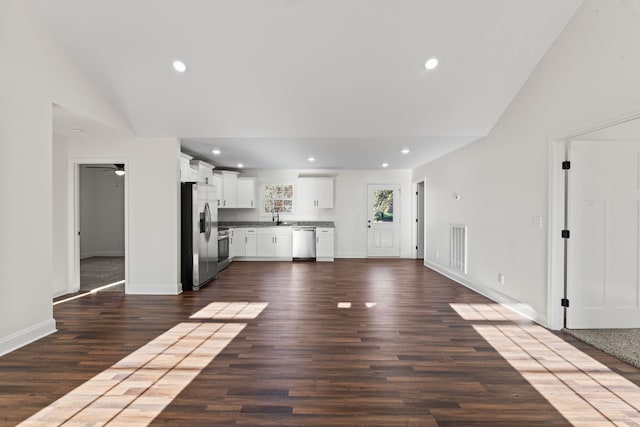 unfurnished living room featuring sink, ceiling fan, lofted ceiling, and dark hardwood / wood-style floors