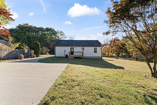 rear view of house featuring a yard