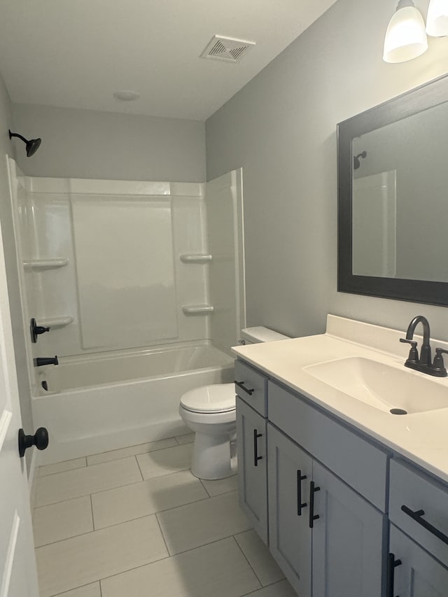 full bathroom featuring vanity, tub / shower combination, toilet, and tile patterned floors