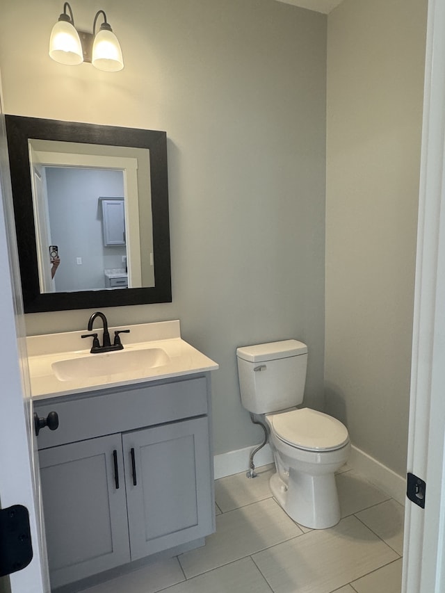 bathroom featuring vanity, toilet, and tile patterned floors