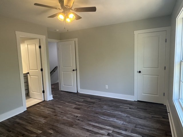 unfurnished bedroom featuring dark hardwood / wood-style floors and ceiling fan