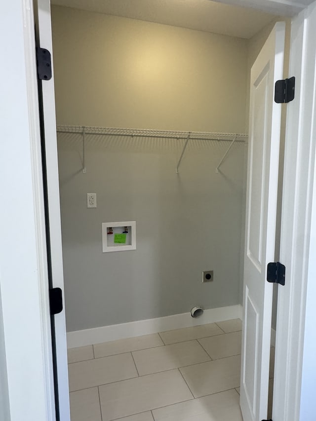 laundry area featuring hookup for an electric dryer, washer hookup, and light tile patterned floors