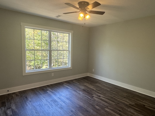 empty room with dark wood-type flooring and ceiling fan