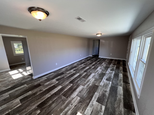 spare room with dark wood-type flooring