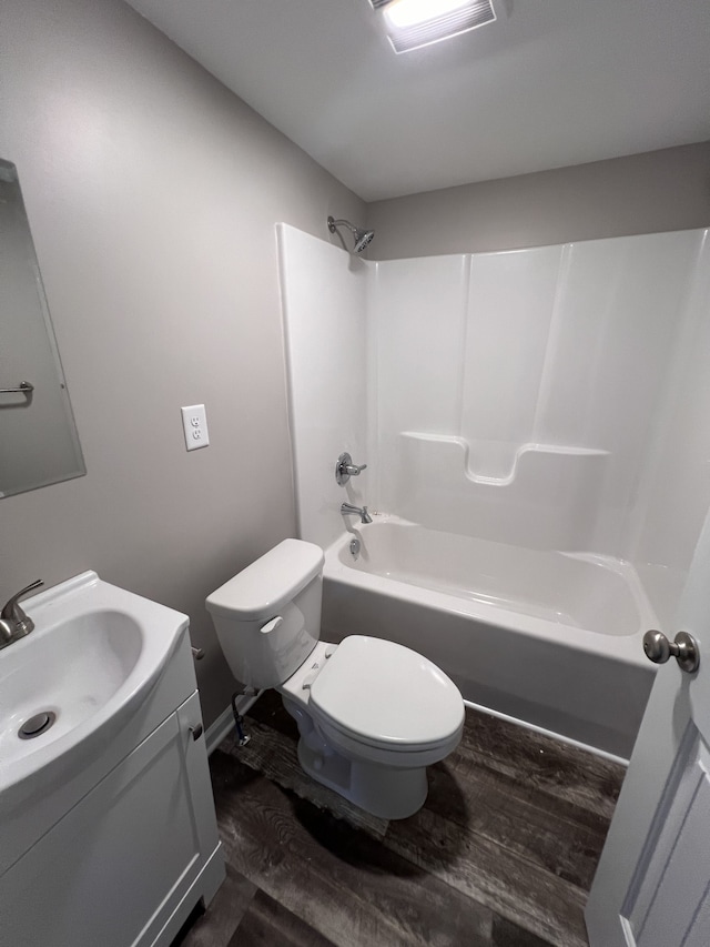 full bathroom featuring vanity, shower / washtub combination, hardwood / wood-style flooring, and toilet