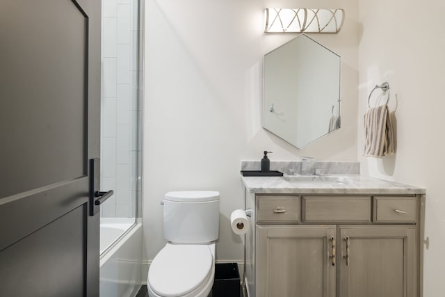 full bathroom with vanity, bath / shower combo with glass door, and toilet