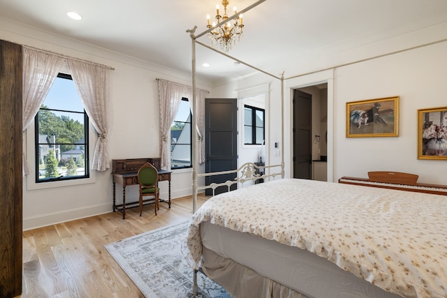 bedroom with ornamental molding, a chandelier, and light wood-type flooring