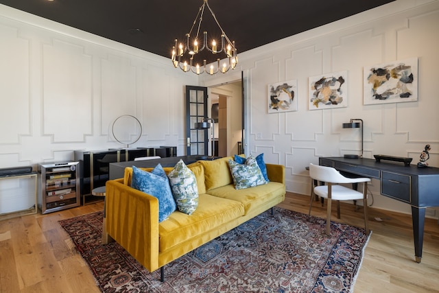 living room featuring light hardwood / wood-style floors and an inviting chandelier