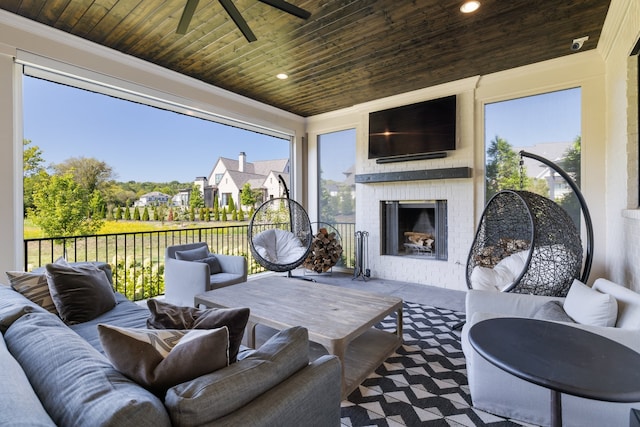 view of patio featuring an outdoor living space with a fireplace and ceiling fan