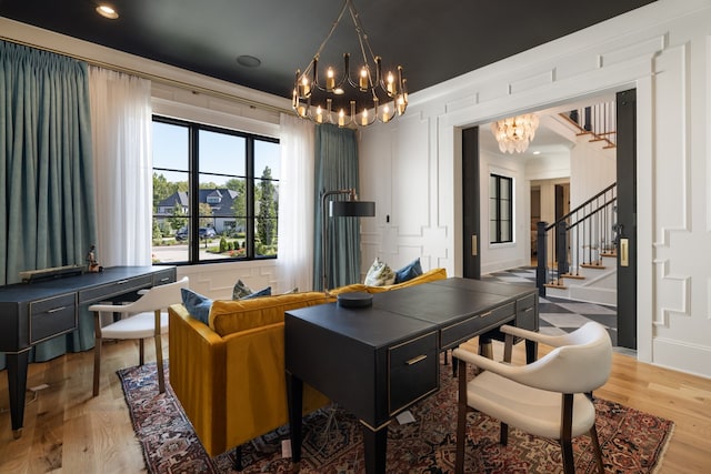 home office featuring crown molding, wood-type flooring, and a chandelier