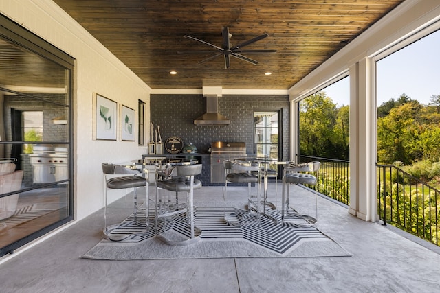 sunroom with a healthy amount of sunlight, wooden ceiling, and ceiling fan