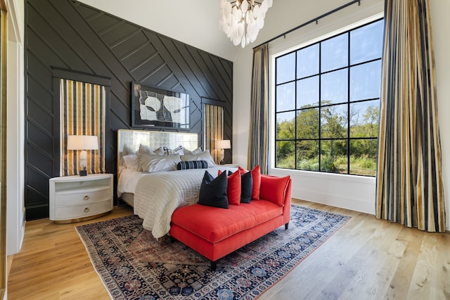 bedroom featuring light hardwood / wood-style floors and wood walls