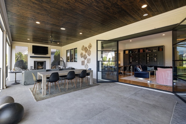 view of patio with an outdoor fireplace and ceiling fan