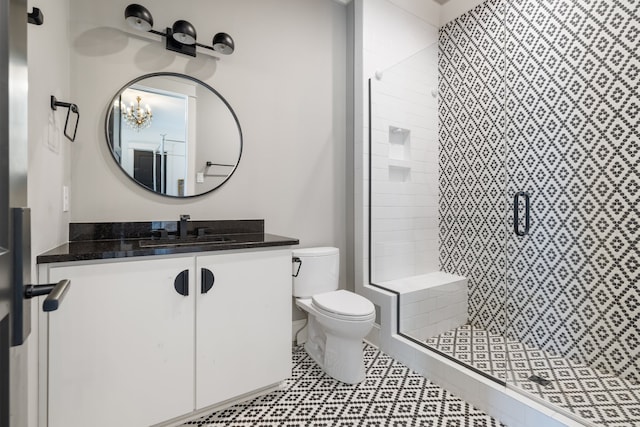 bathroom with vanity, toilet, and an enclosed shower