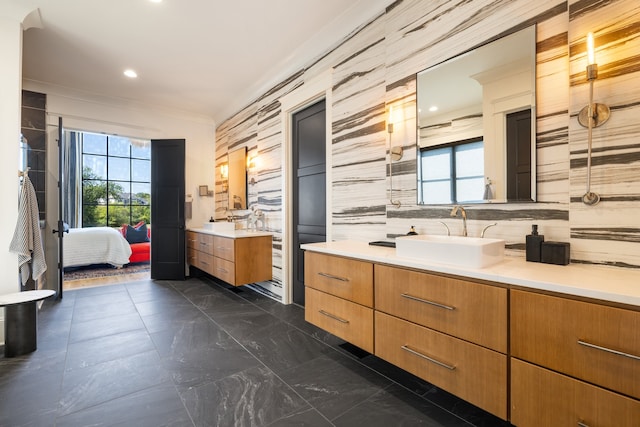 bathroom with vanity, tile walls, tasteful backsplash, and plenty of natural light