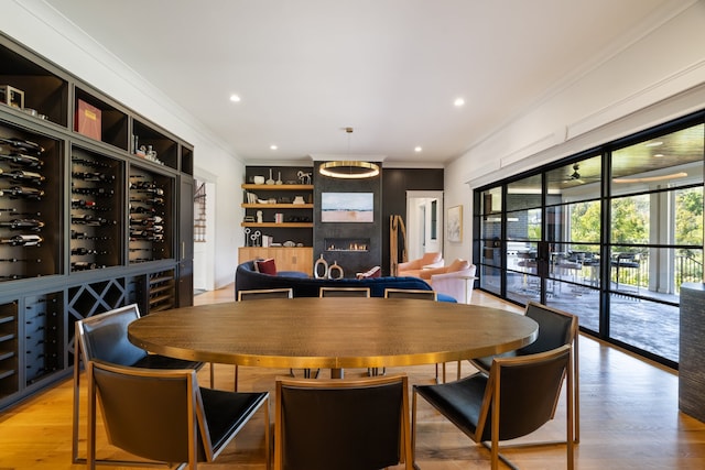 dining space with hardwood / wood-style floors and crown molding