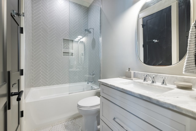 full bathroom featuring vanity, tiled shower / bath, toilet, and tile patterned flooring