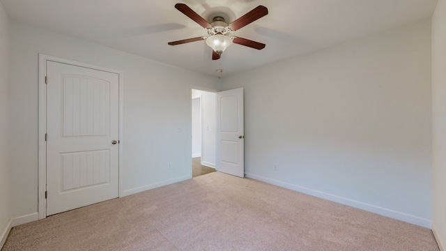 unfurnished room featuring ceiling fan and light colored carpet