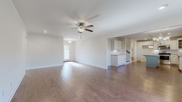 unfurnished living room with ornamental molding, hardwood / wood-style flooring, and ceiling fan with notable chandelier