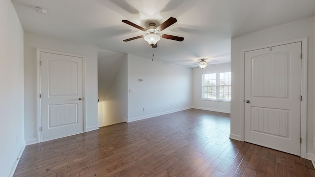 spare room featuring dark wood-type flooring and ceiling fan