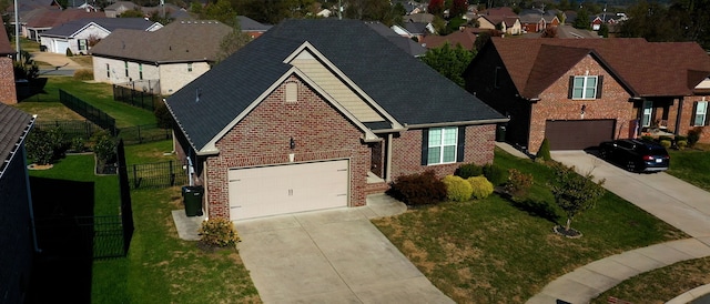 view of front of home featuring a front yard and a garage