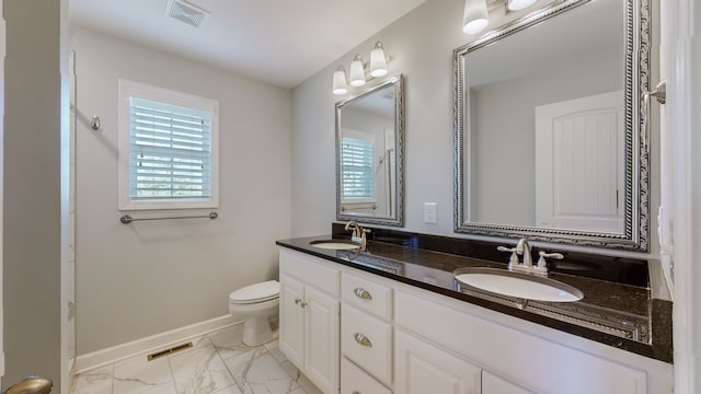 bathroom featuring vanity and toilet