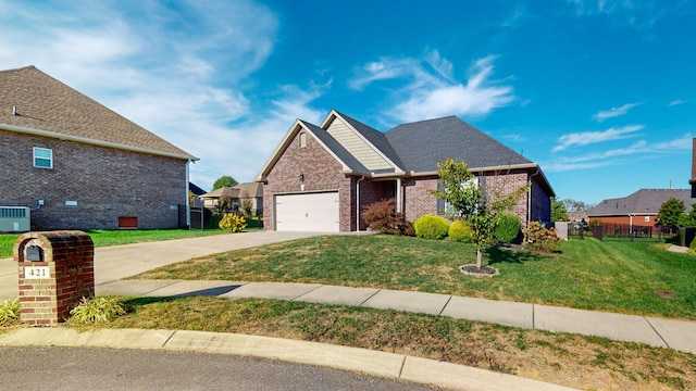 view of front of home with a front yard and a garage