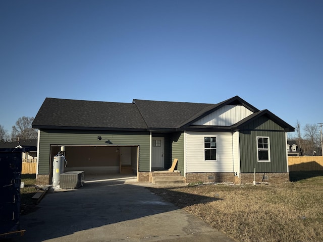 view of front of house with a garage and central AC