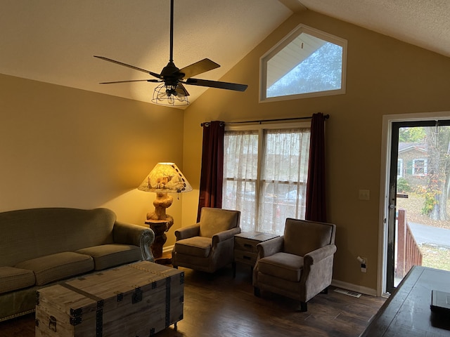 living room featuring a textured ceiling, ceiling fan, high vaulted ceiling, and dark hardwood / wood-style flooring