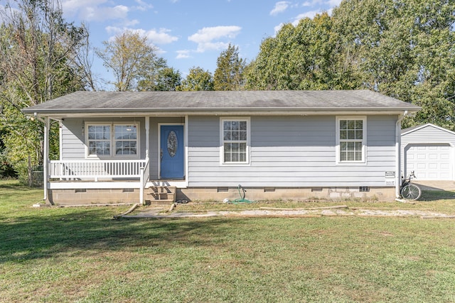 view of front of home with a front lawn, a porch, an outbuilding, and a garage