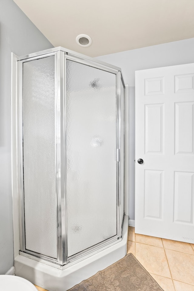 bathroom with tile patterned floors and an enclosed shower