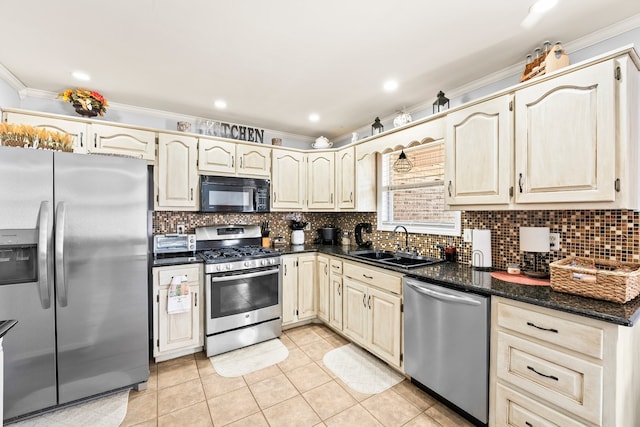 kitchen featuring tasteful backsplash, appliances with stainless steel finishes, dark stone counters, ornamental molding, and sink