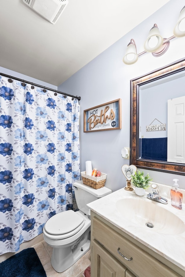 bathroom with vanity, toilet, a shower with shower curtain, and tile patterned flooring