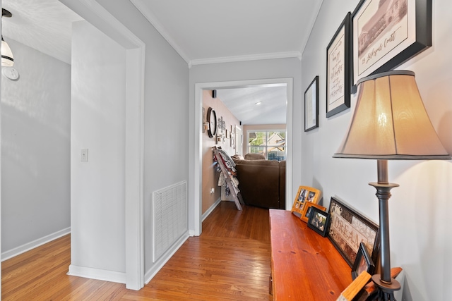 hallway featuring light hardwood / wood-style floors and crown molding