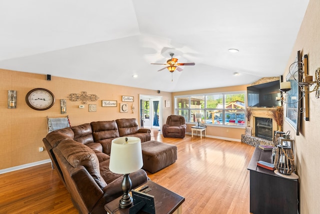 living room with ceiling fan, vaulted ceiling, and hardwood / wood-style floors